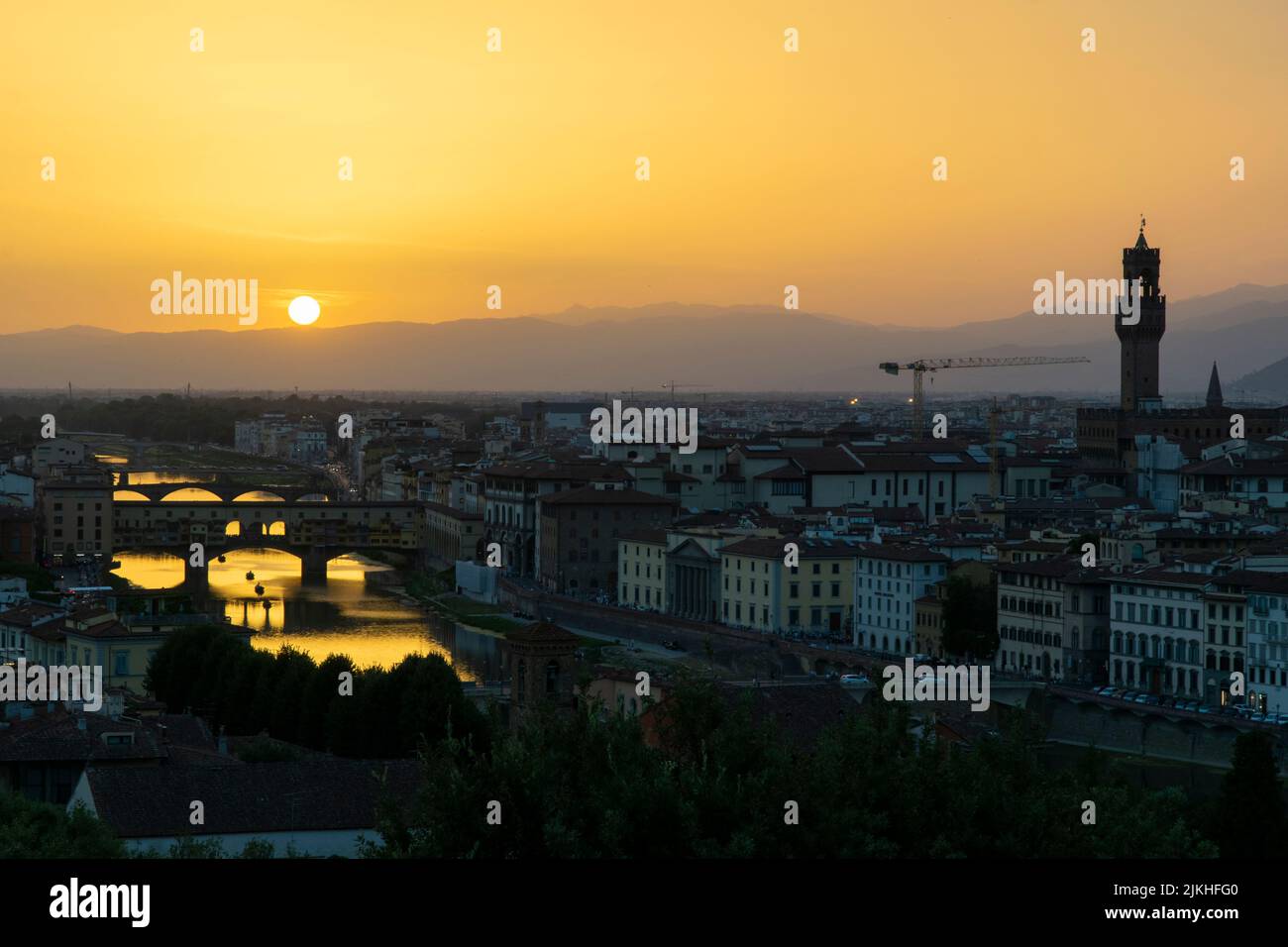 Sunset landscape in Florence, Tuscany. Ponte Vecchio and the Arno river on the left side Stock Photo