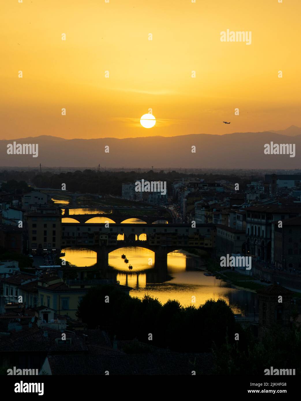 Sunset over Florence. Ponte Vecchio and the Arno river on the bottom side Stock Photo