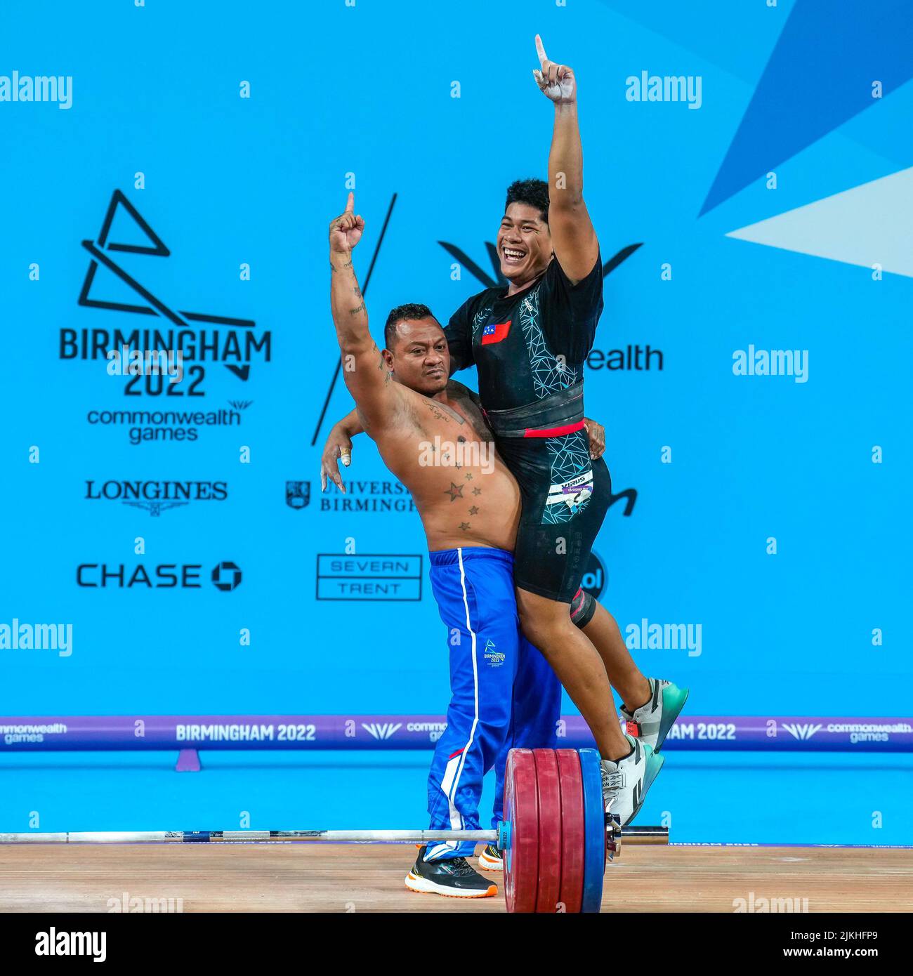 Birmingham, UK. 02nd Aug, 2022. Don OPELOGE (SAM) (right) celebrates after securing Gold in the 2022 Commonwealth Games Men's 96kg Weightlifting Final with Games Records in the Snatch (171kg) and Clean & Jerk (210kg) at the NEC, Birmingham, England on the 2 August 2022. Photo by David Horn. Credit: PRiME Media Images/Alamy Live News Stock Photo