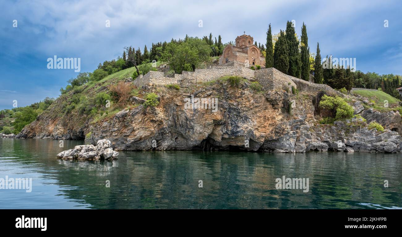 A distant view of the Saint John church on the cliff surrounded by Lake Ohrid in North Macedonia Stock Photo
