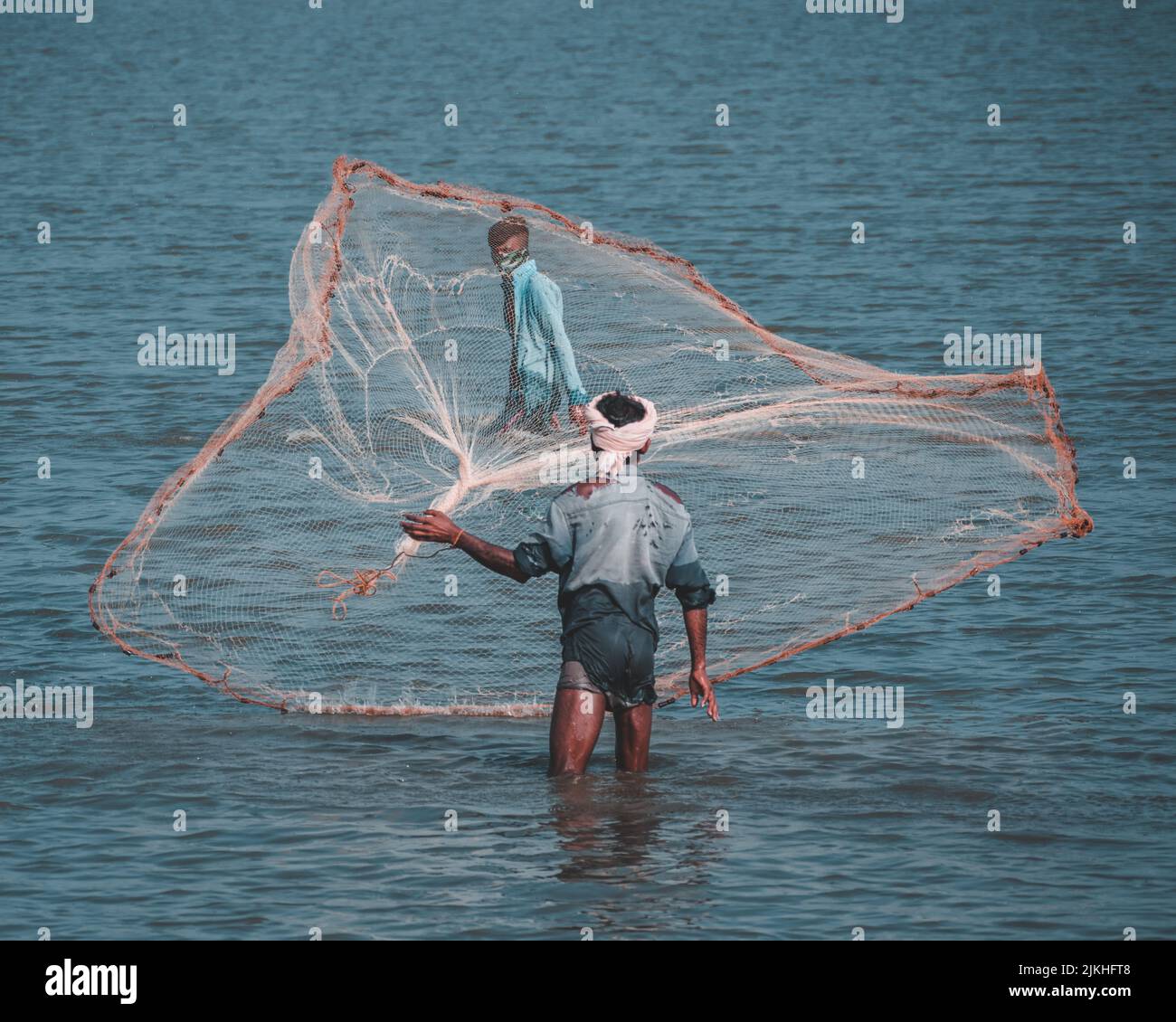Fisherman throwing net catch fish hi-res stock photography and images -  Alamy
