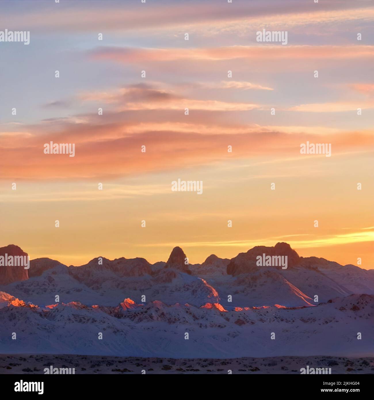 A dramatic sunset in vibrant colors over the snowy mountains Stock ...