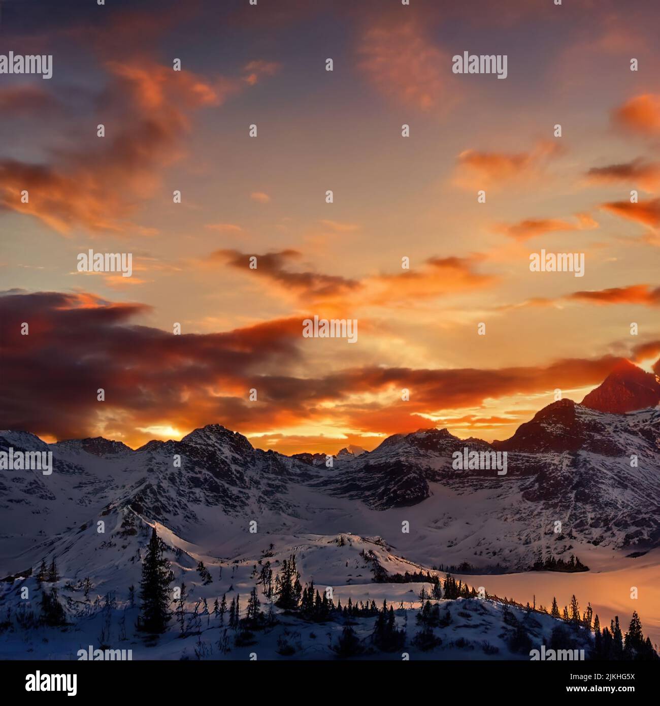 A scenic view of a beautiful sunset above a snowy mountain range Stock ...