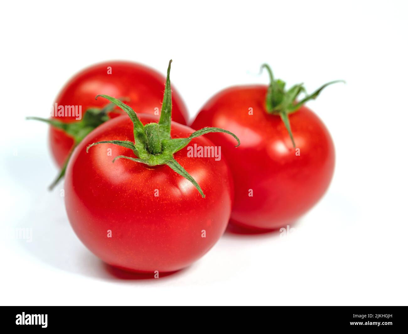 Vine tomatoes isolated against white background Stock Photo - Alamy