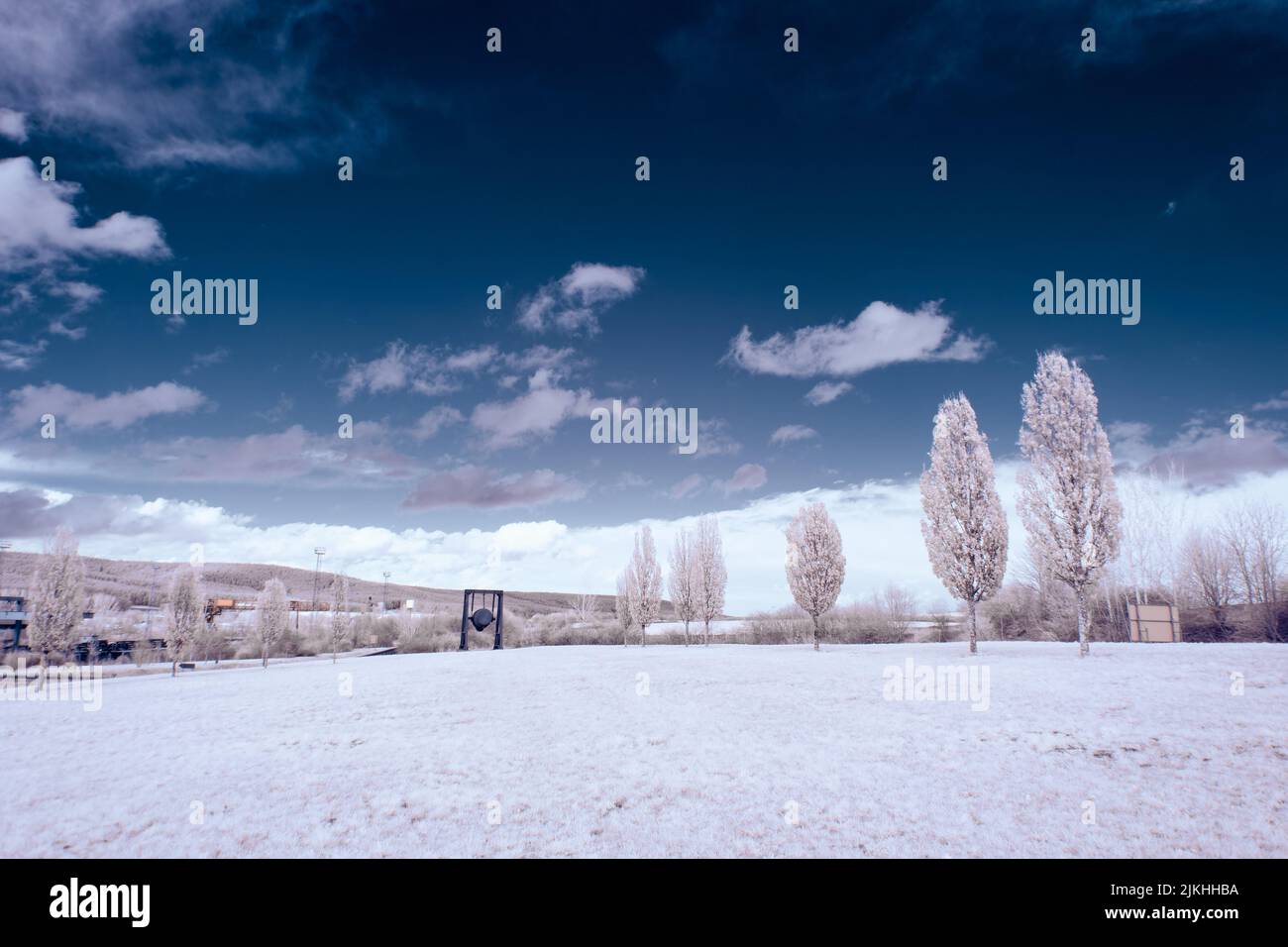 A landscape with snowy trees under sky with clouds Stock Photo - Alamy