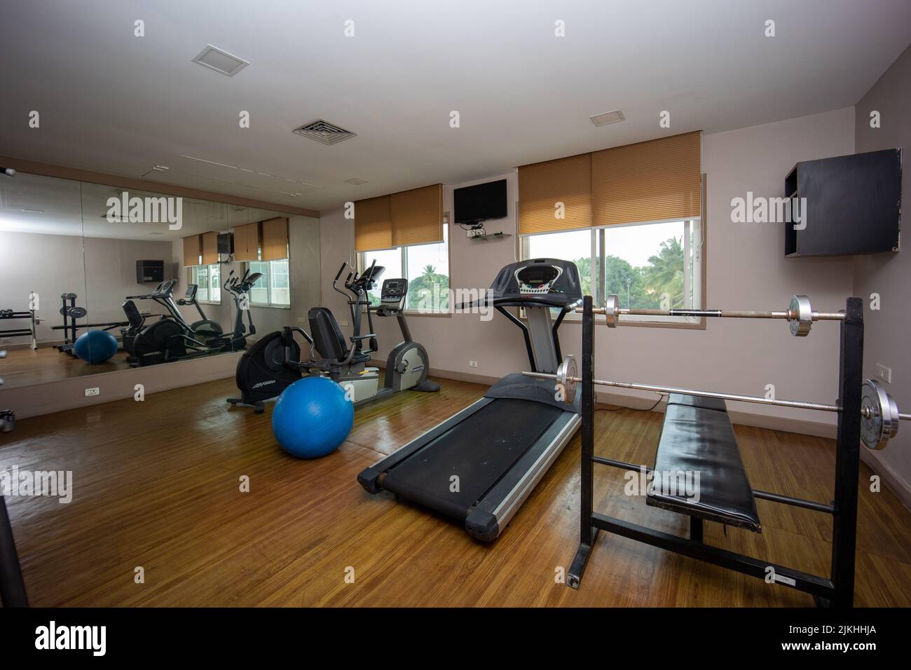 A small gym room with several expensive equipments for training Stock Photo