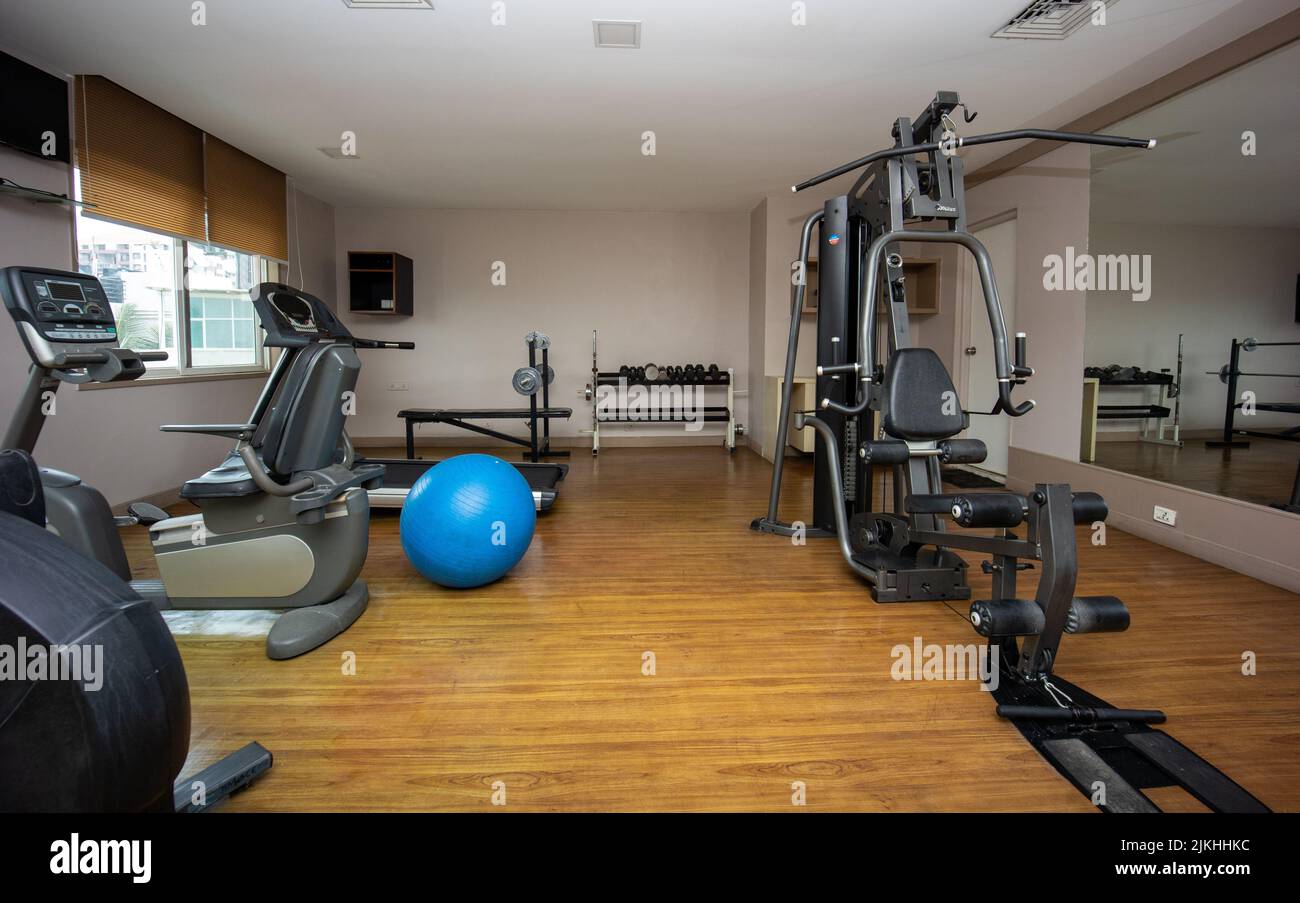 A small gym room with several expensive equipments for training Stock Photo