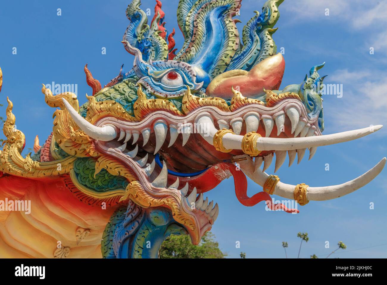 A closeup of a dragon head at a small village temple in Thailand Stock Photo