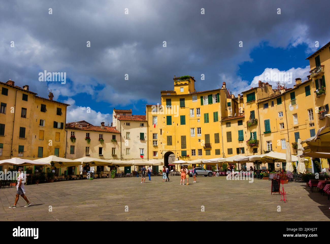 The famous Piazza dell'Anfiteatro (Amphitheater Square) in the historic center of Lucca, with houses, shops and restaurants built over ancient roman a Stock Photo