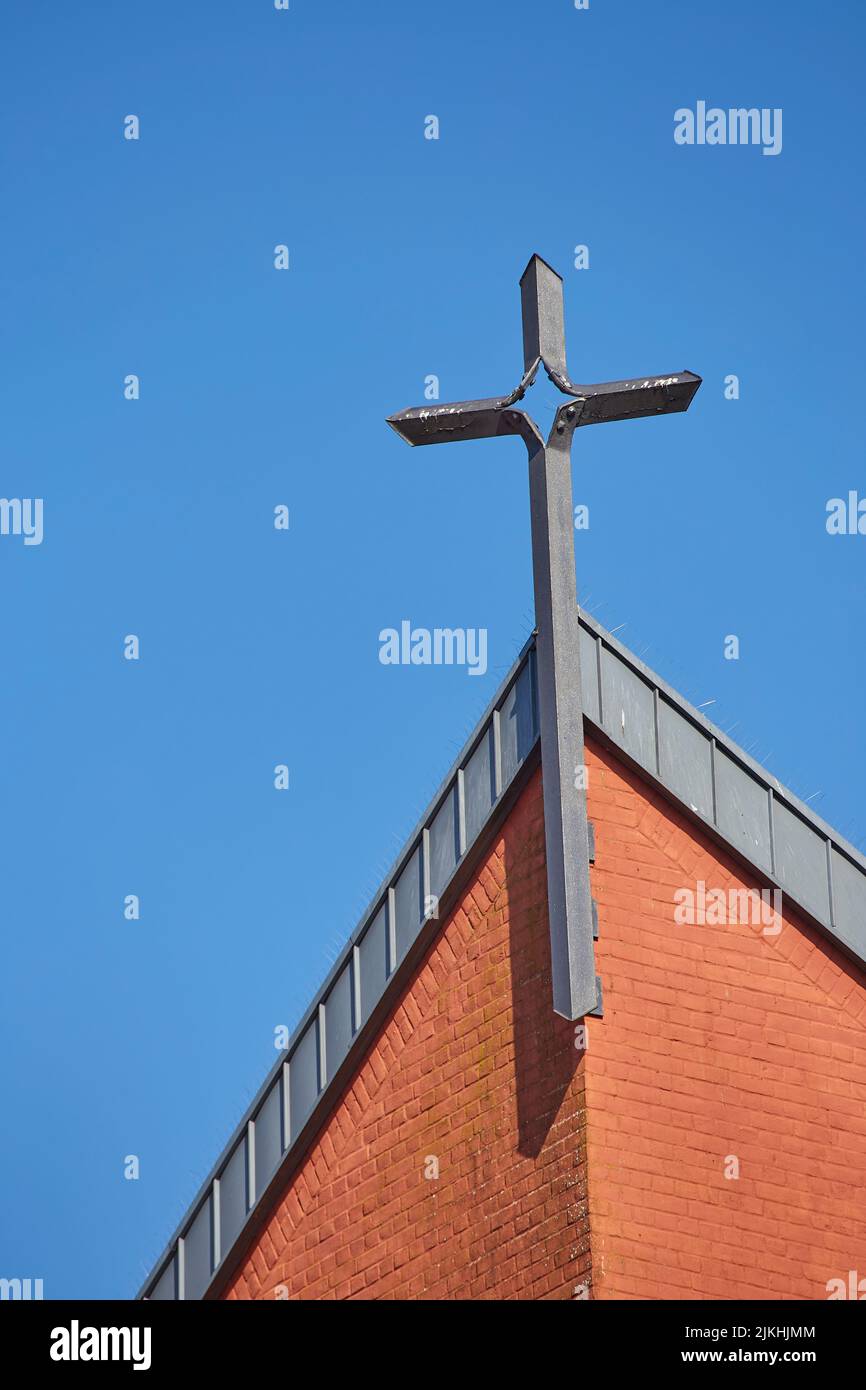 A vertical shot of a cross on the St.Philip Neri Church in Aachen