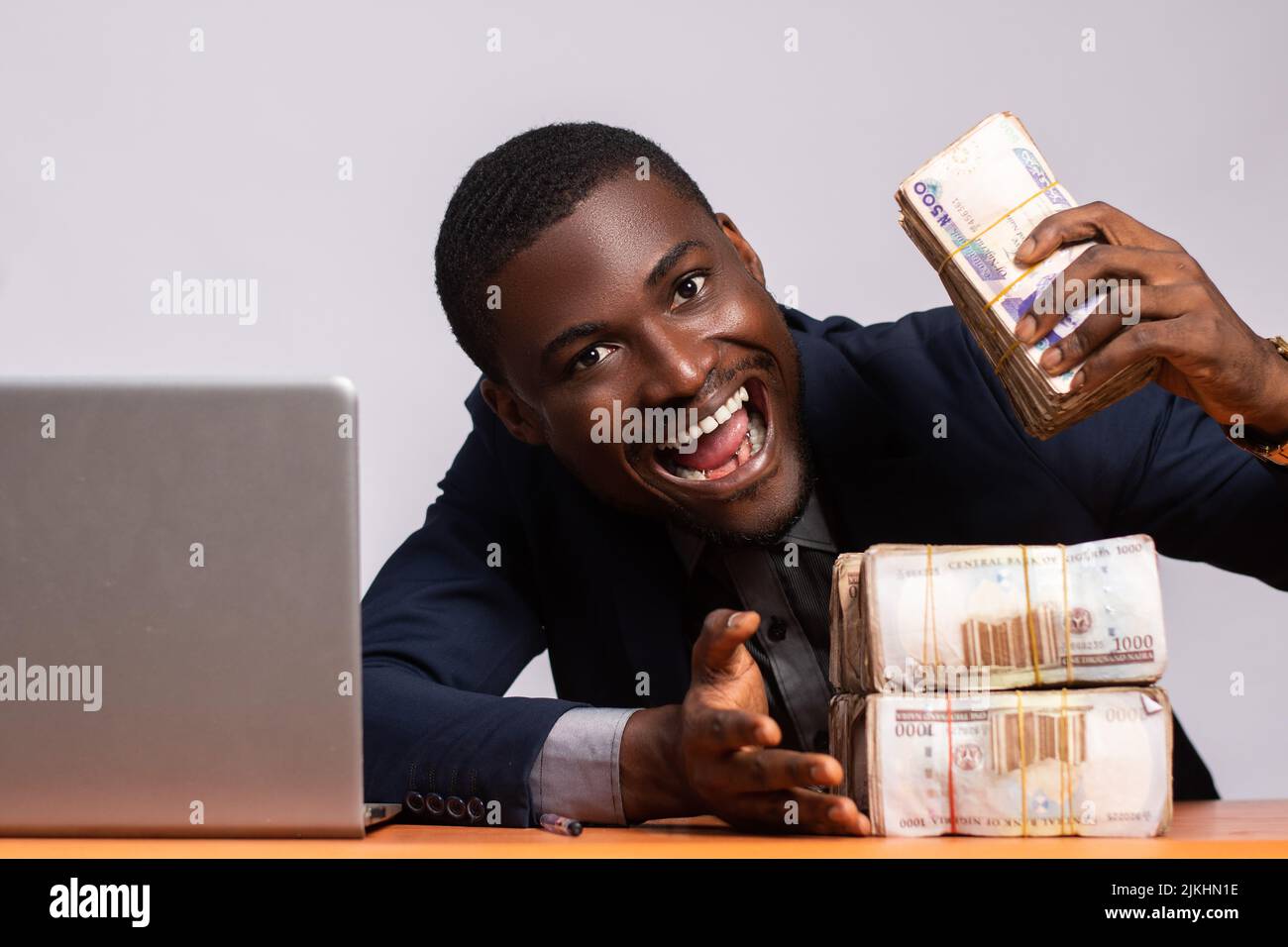 excited black businessman with a lot of cash Stock Photo - Alamy