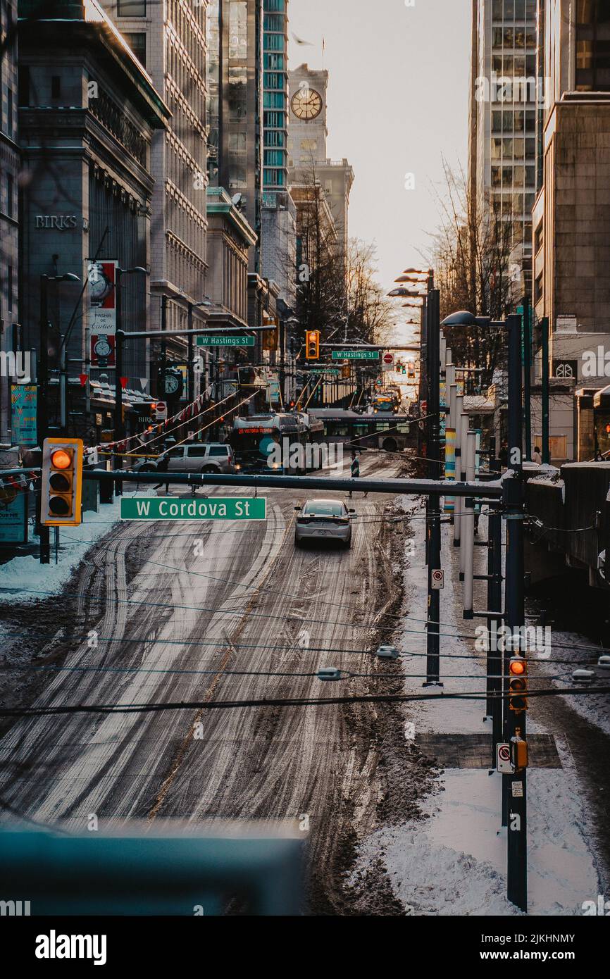 A vertical shot of a yellow Toyota car parked on the street during winter in Vancouver, Canada Stock Photo