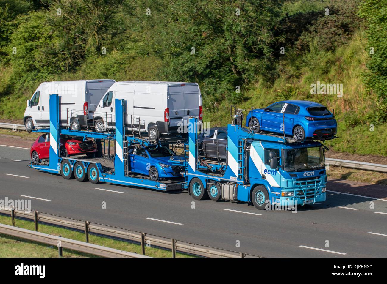 ECM 2017 Scania P419 tilt and slide car transporter. Transporting Vauxhall Movano vans on the M6 motorway UK Stock Photo