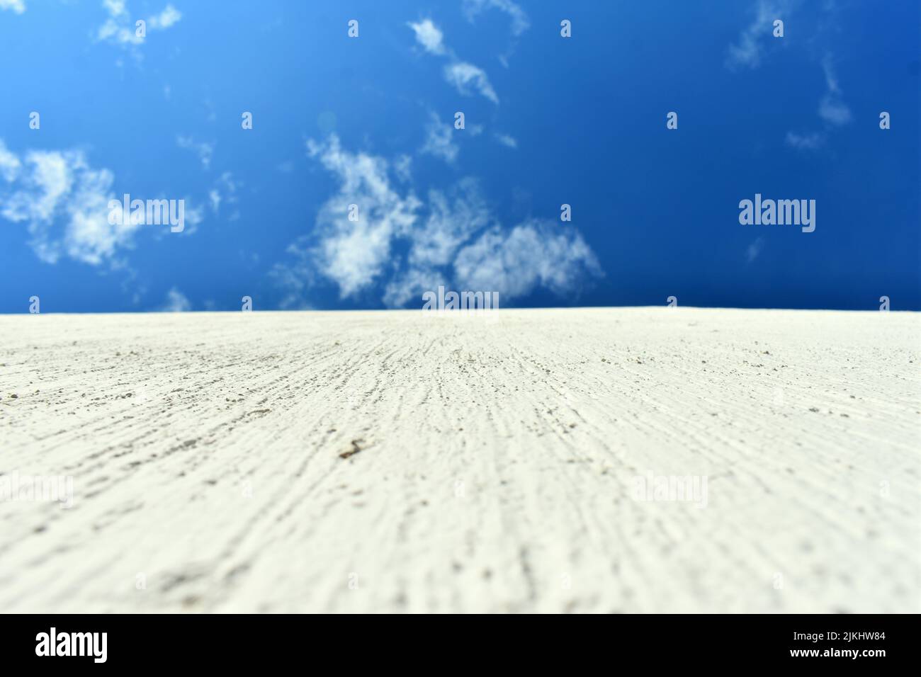a shot of white concrete wall agaisnt blue sky Stock Photo
