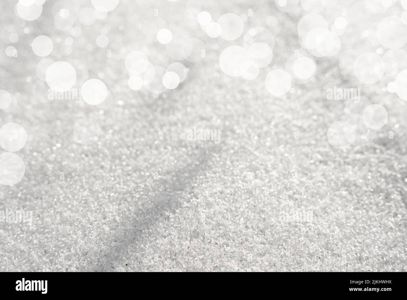 A white snow texture background with blurred bokeh circles above Stock Photo