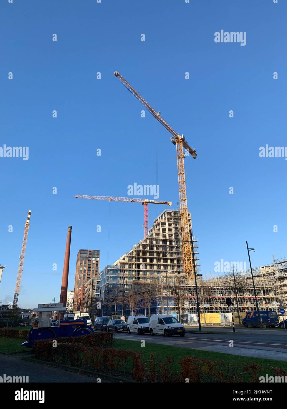 A vertical shot of a construction site building with cranes in Eindhoven, Netherlands Stock Photo
