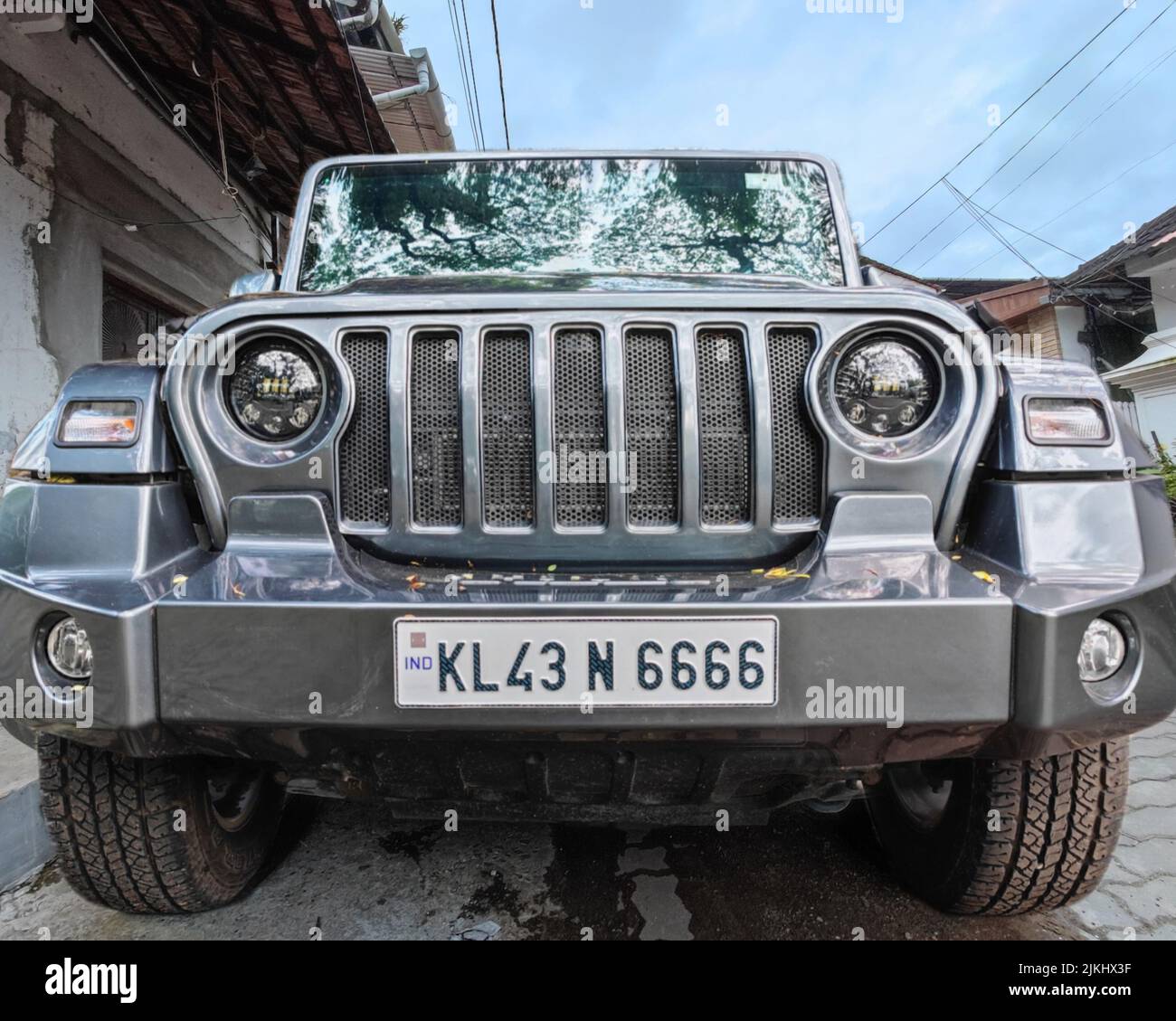 A front view shot of a Mahindra Thar, Sport utility vehicle model against a blue sky Stock Photo