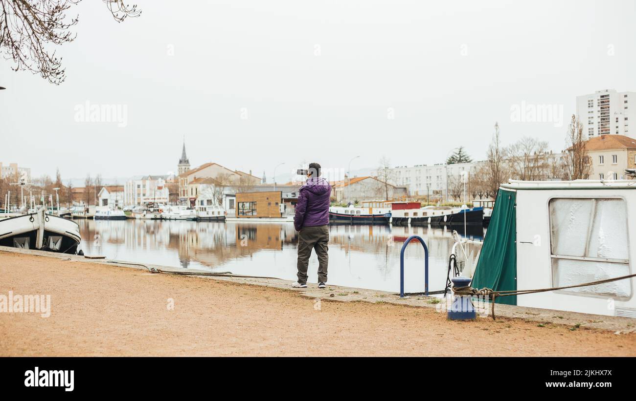 handsome Latin man in port taking picture with his mobile Stock Photo