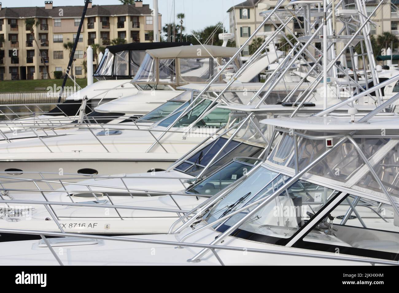 A Close up side shot of a row of docked boats and yachts Stock Photo