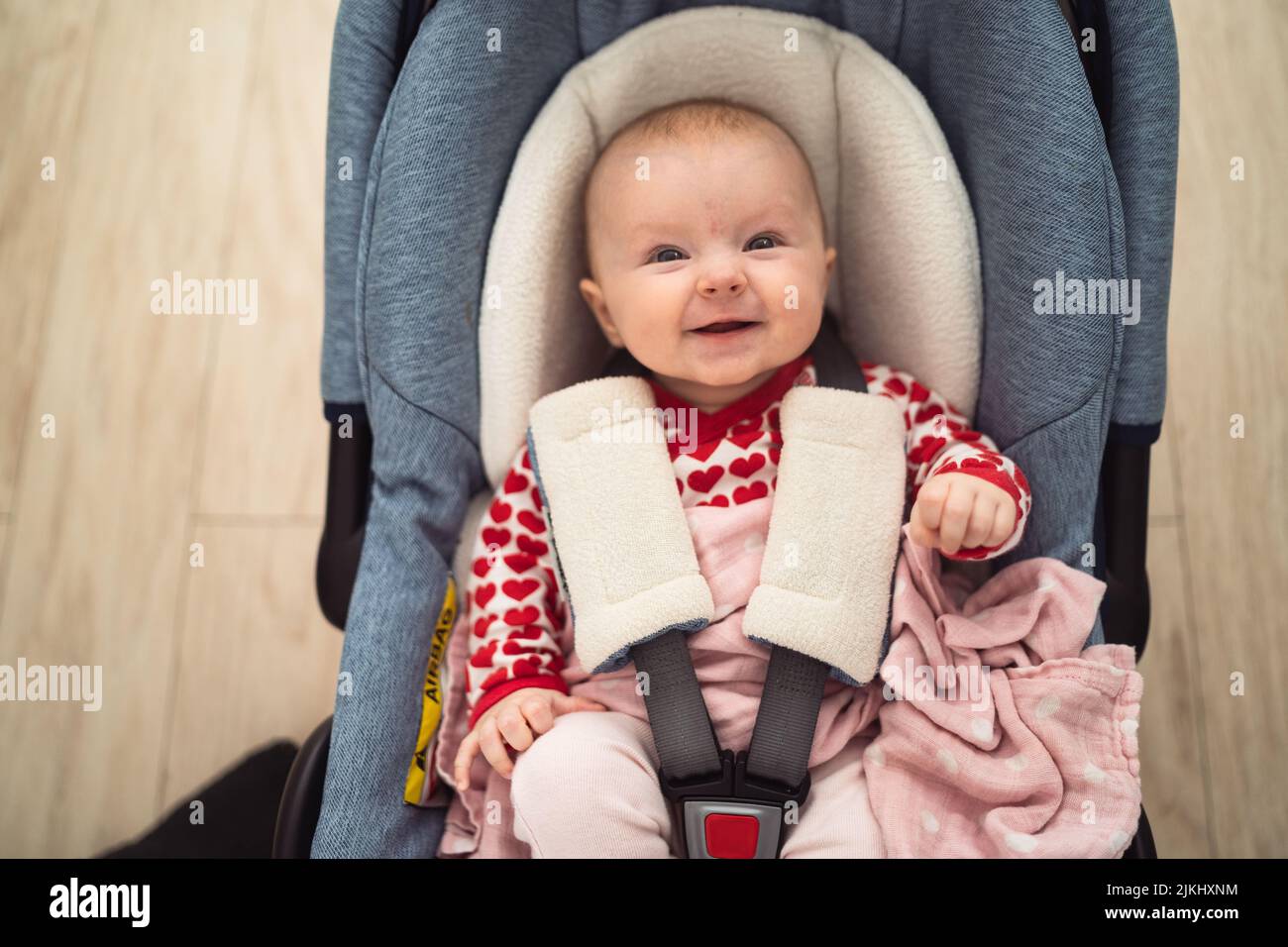 Small baby sitting in a car seat, baby girl Stock Photo Alamy