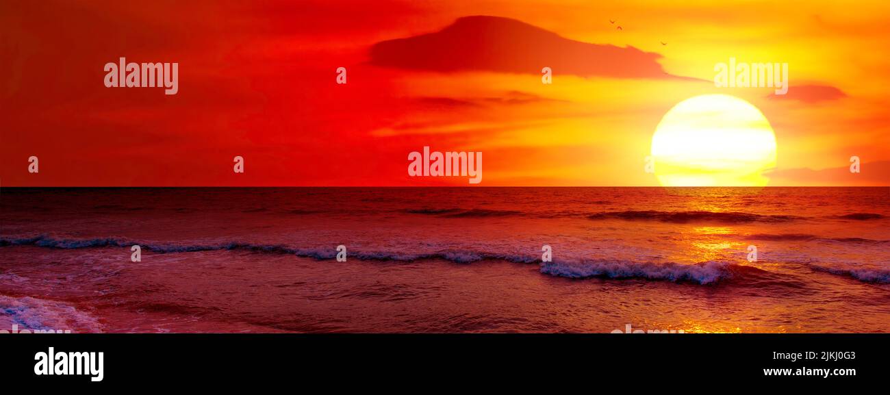 Fantastic sunset over ocean, sea waves and sand. Stock Photo