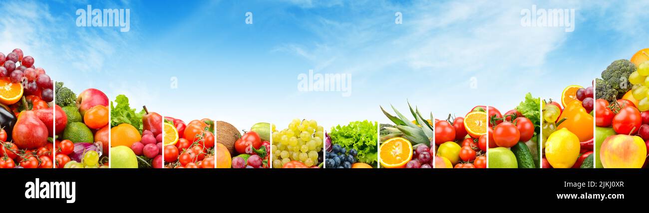 Vegetables and fruits separated vertical lines against blue sky. Copy space Stock Photo