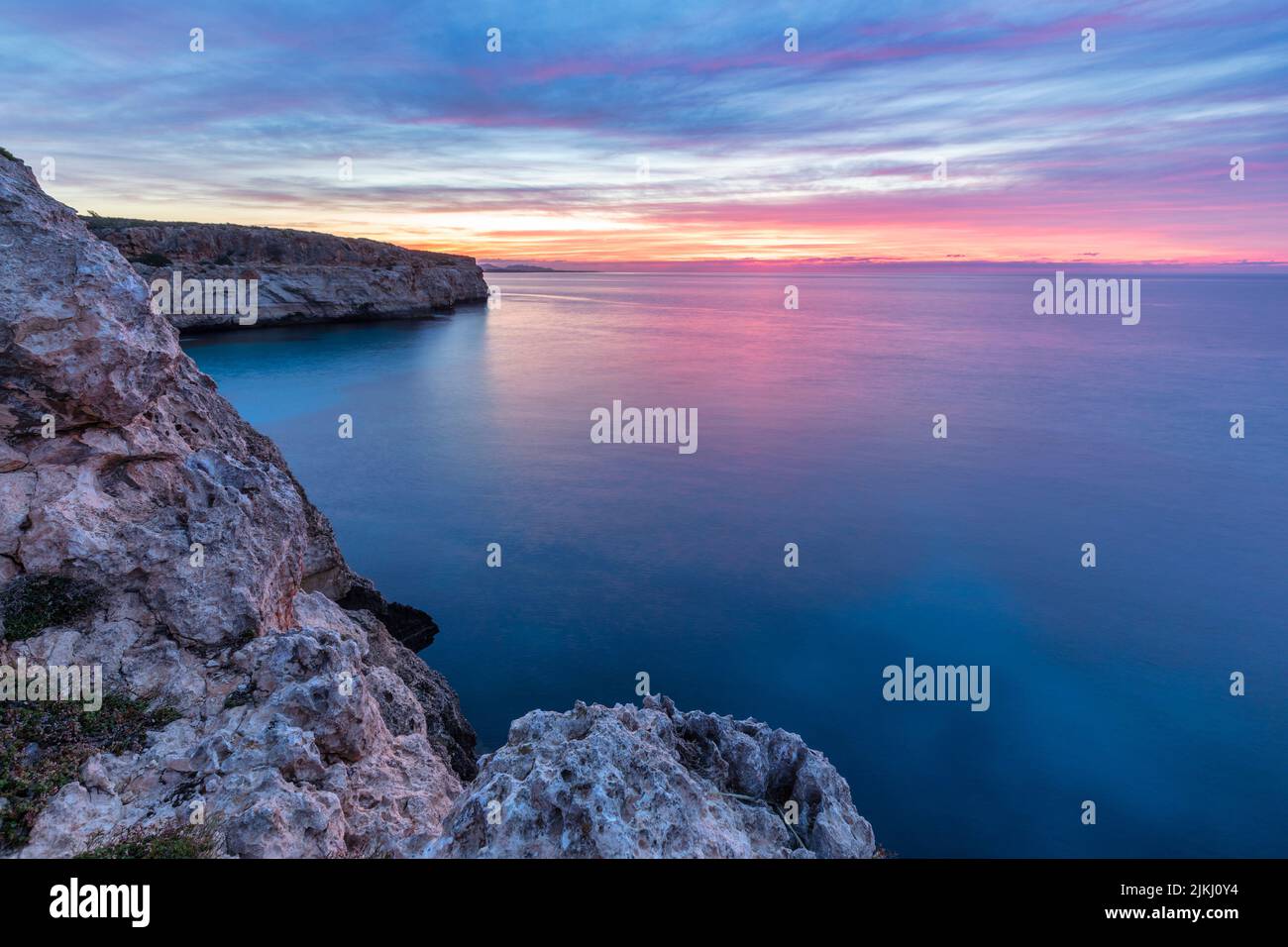 Spain, Balearic islands, Mallorca, district of Manacor, Cales de Mallorca. Sunrise on the sea near Ansa de S'Estri Stock Photo