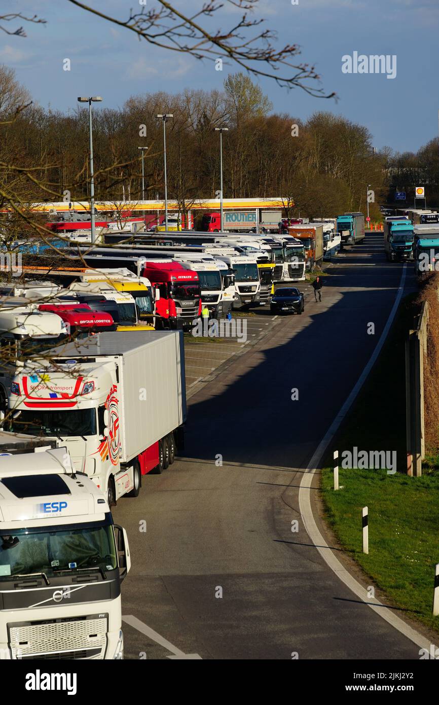 Parking trucks at a truck stop beside a motorway in on a beautiful sunny day in Viersen, Germany. Stock Photo