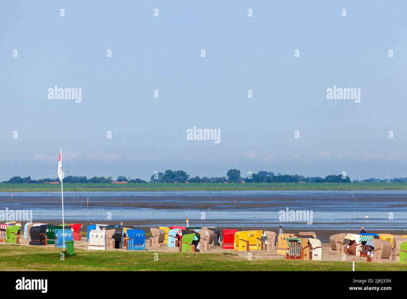 Beach, mudflats, beach chairs, in the background Wilhelmshaven, North Sea resort Dangast, Varel-Dangast, Lower Saxony, Germany, Europe Stock Photo