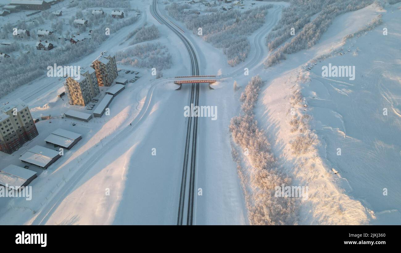 An areal view of roads and bridge near the small town all covered by snow Stock Photo