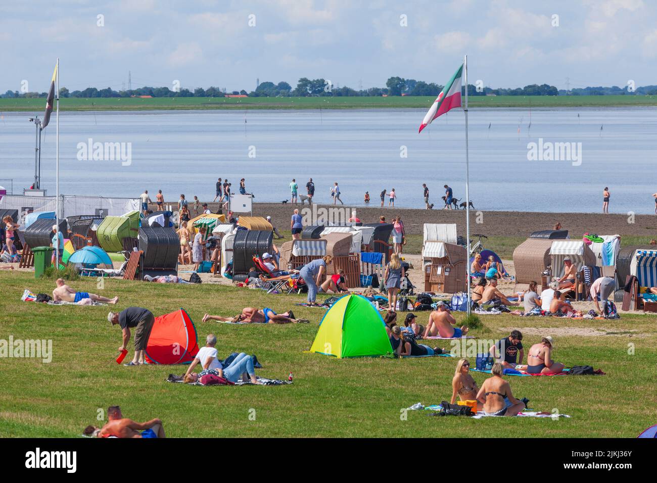 Beach, mudflats, beach chairs, in the background Wilhelmshaven, North Sea resort Dangast, Varel-Dangast, Lower Saxony, Germany, Europe Stock Photo