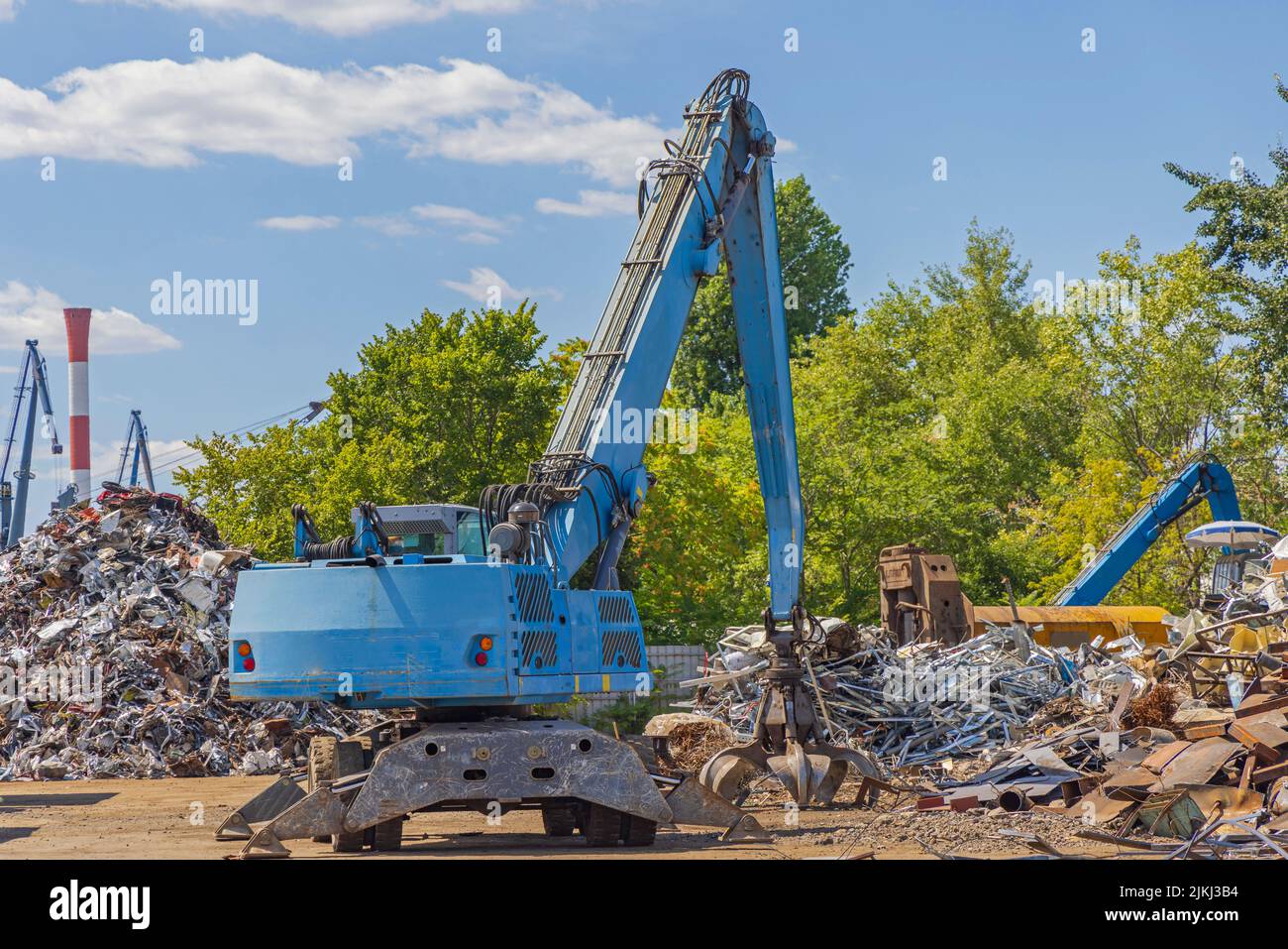 Machine With Peel Grapple at Scrapyard Recycling Facility Stock Photo
