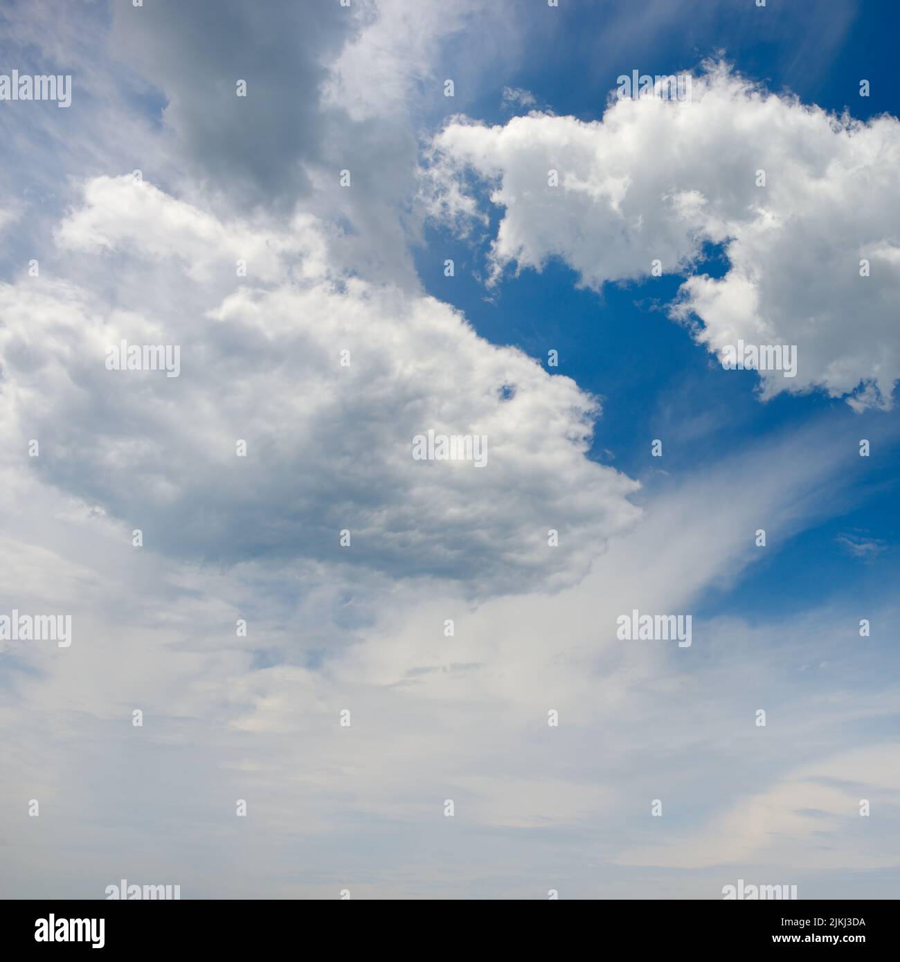 Large white clouds against blue sky. Heavenly landscape. Stock Photo