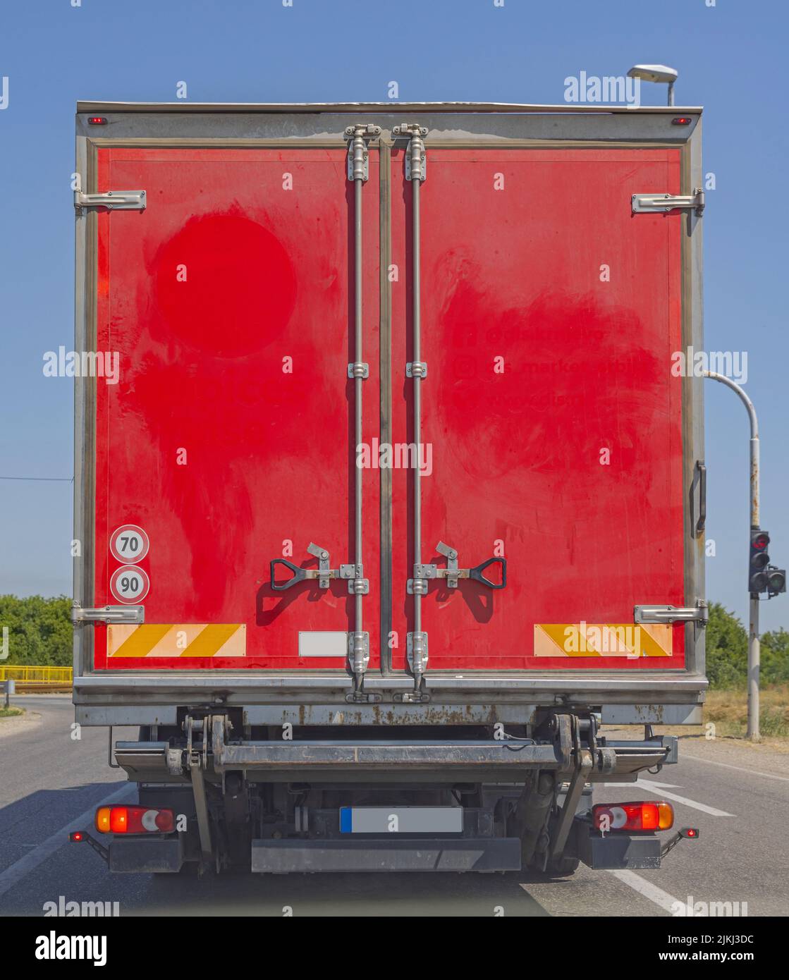 Closed Rear Doors at Red Truck With Folded Ramp Stock Photo