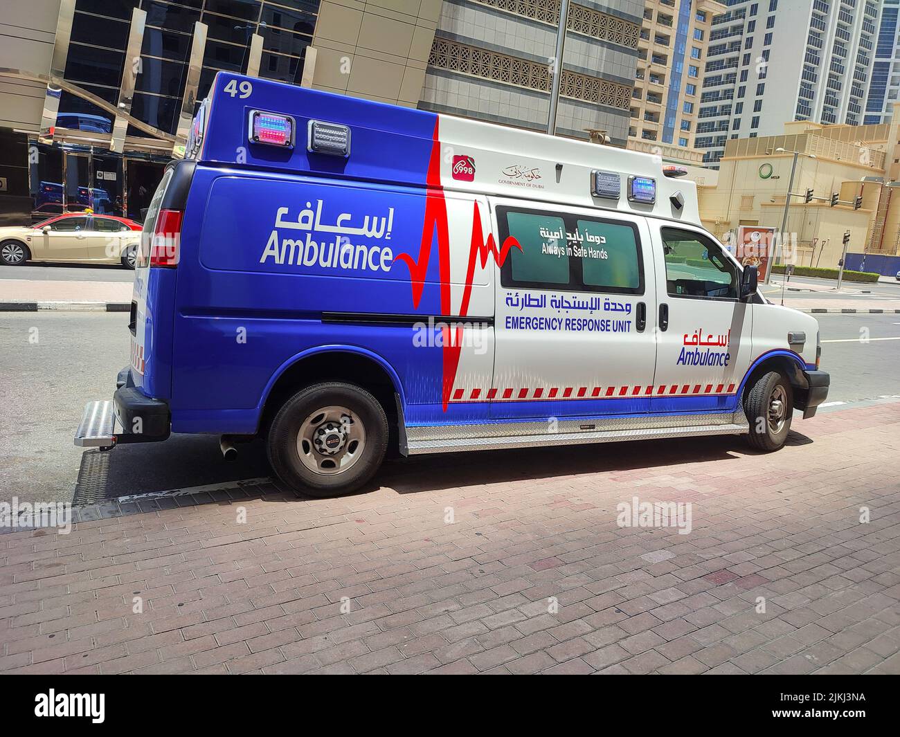 A blue and white colored ambulance truck in the Dubai parking in black ...