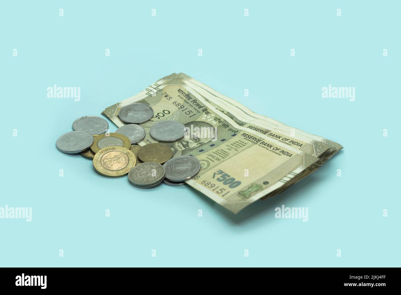 The Indian currency - 500 rupee note with Indian coins. Stock Photo