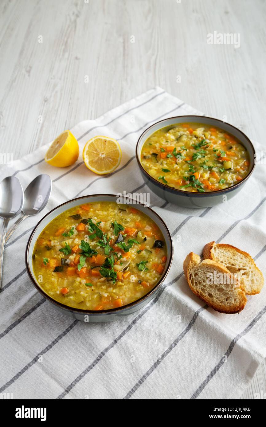 Homemade fresh lemon rice soup in a bowl, low angle view. Copy space. Stock Photo