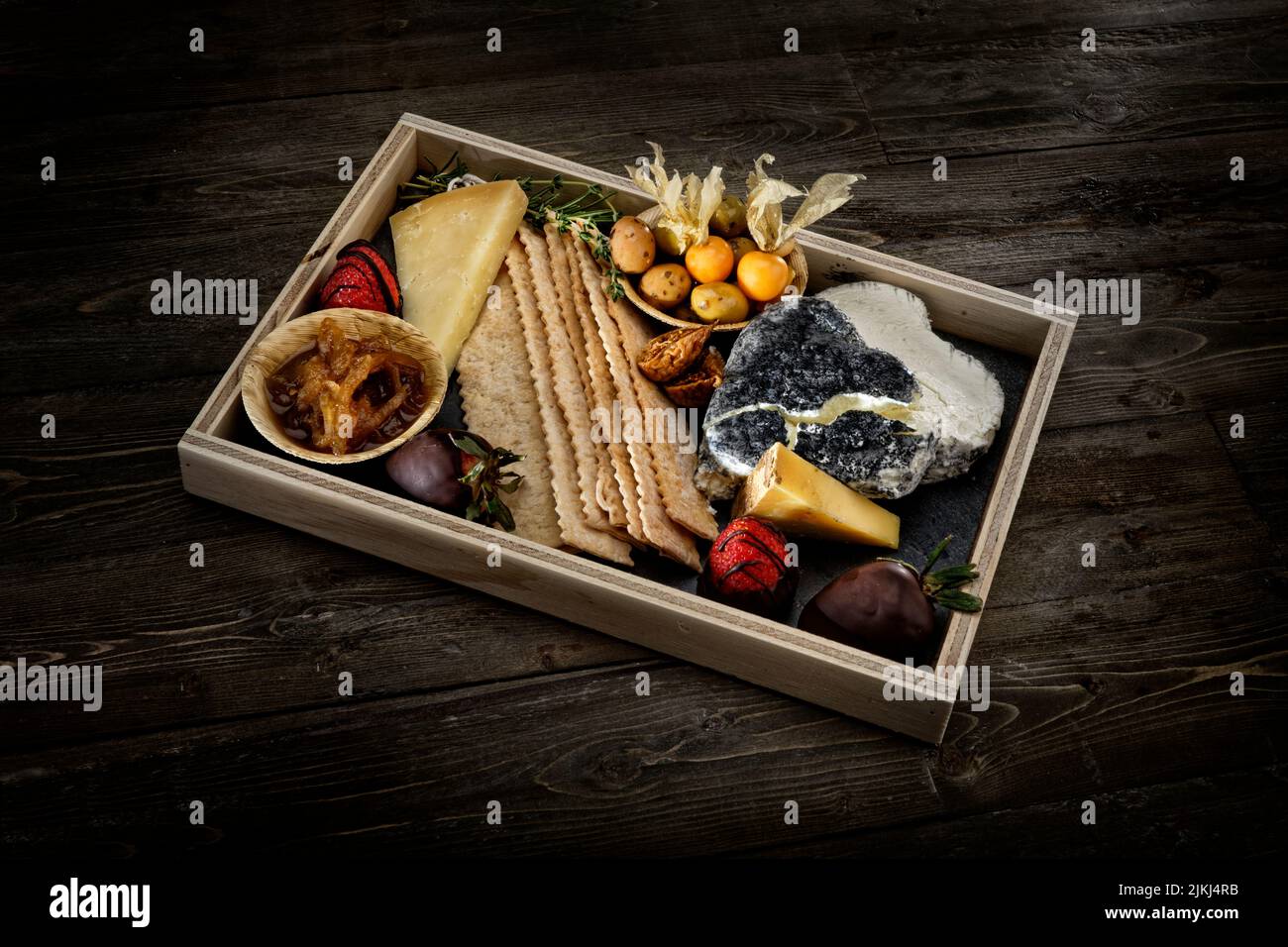 A delicious Charcuterie board with cheese, crackers, and cured meats Stock Photo