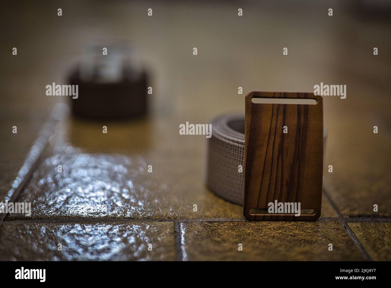 A selective shot of two Grip6 webbing strap belts on the tiles Stock