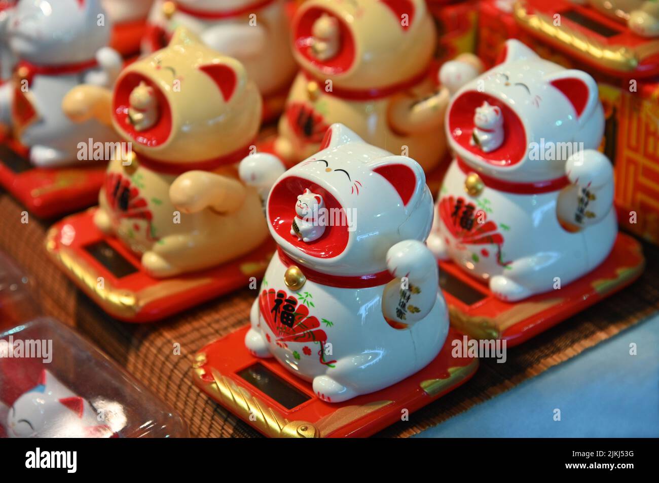 The welcoming cat oriental souvenirs on sale in oriental fair selective in Turin, Italy Stock Photo