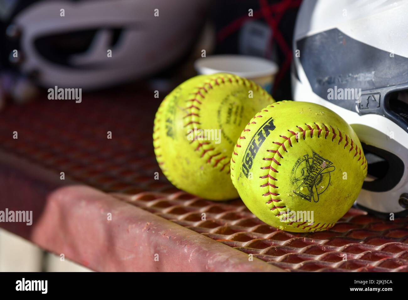 The Softballs on a dugout bench Stock Photo Alamy