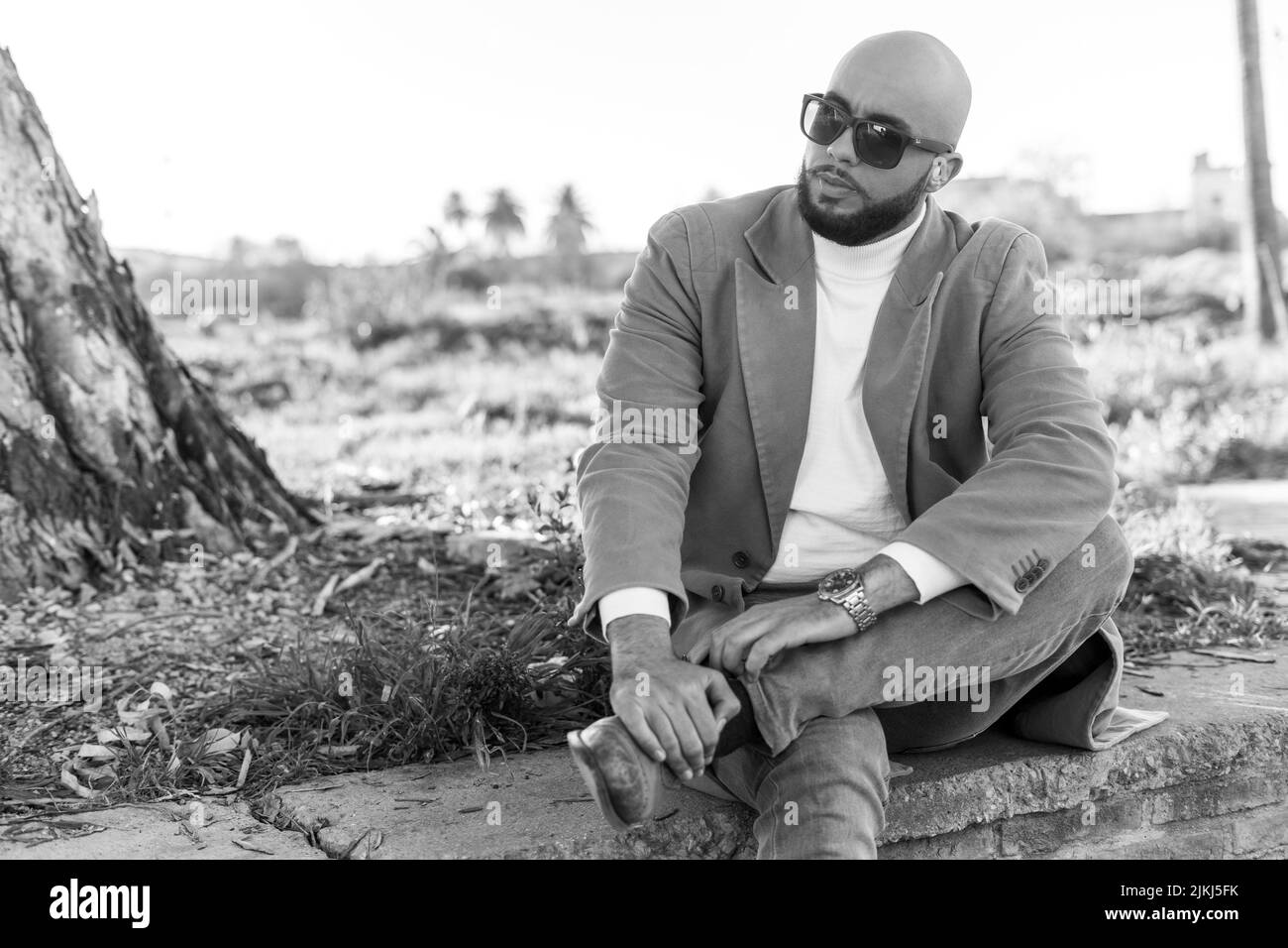Black and white shot of an attractive Caucasian man posing in front of ...