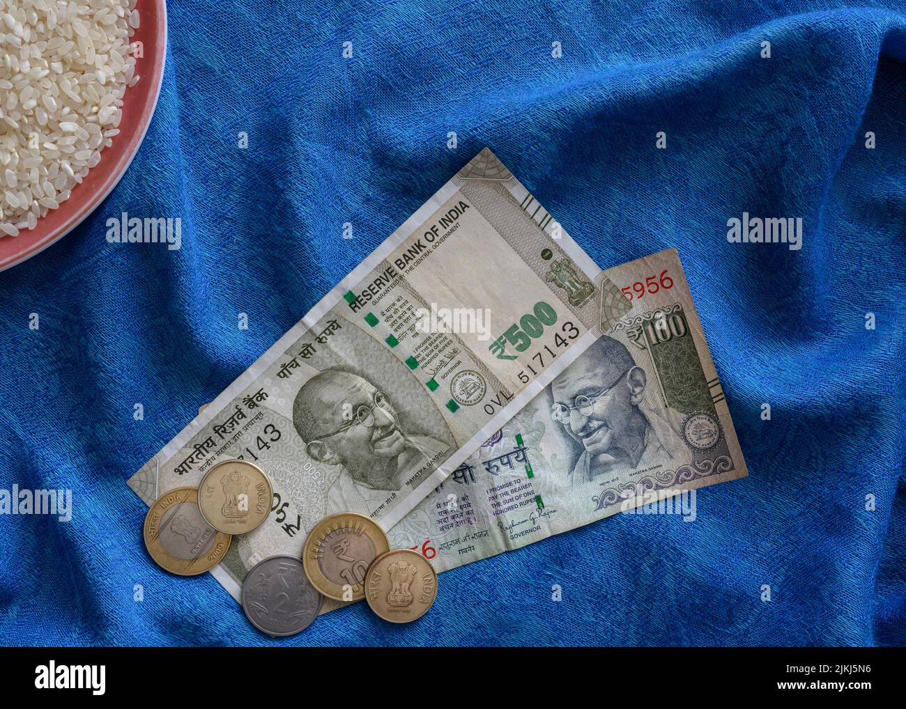 Coins and paper banknotes of Indian rupees on a background of blue