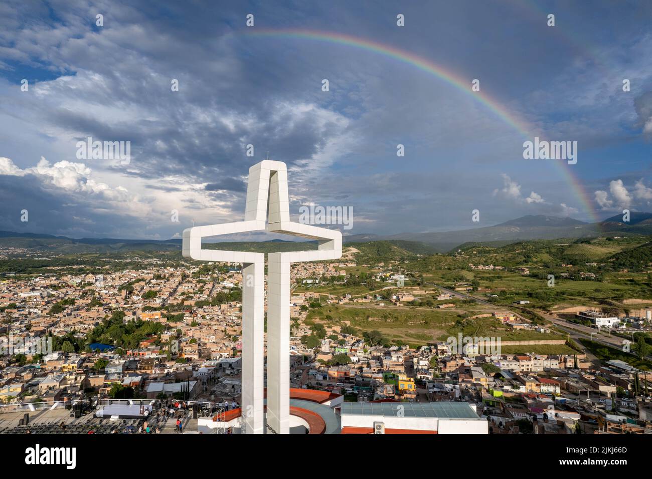 A rainbow over the Santa Cruz and the cityscape of the Calvillo  in Aguascalientes, Mexico Stock Photo