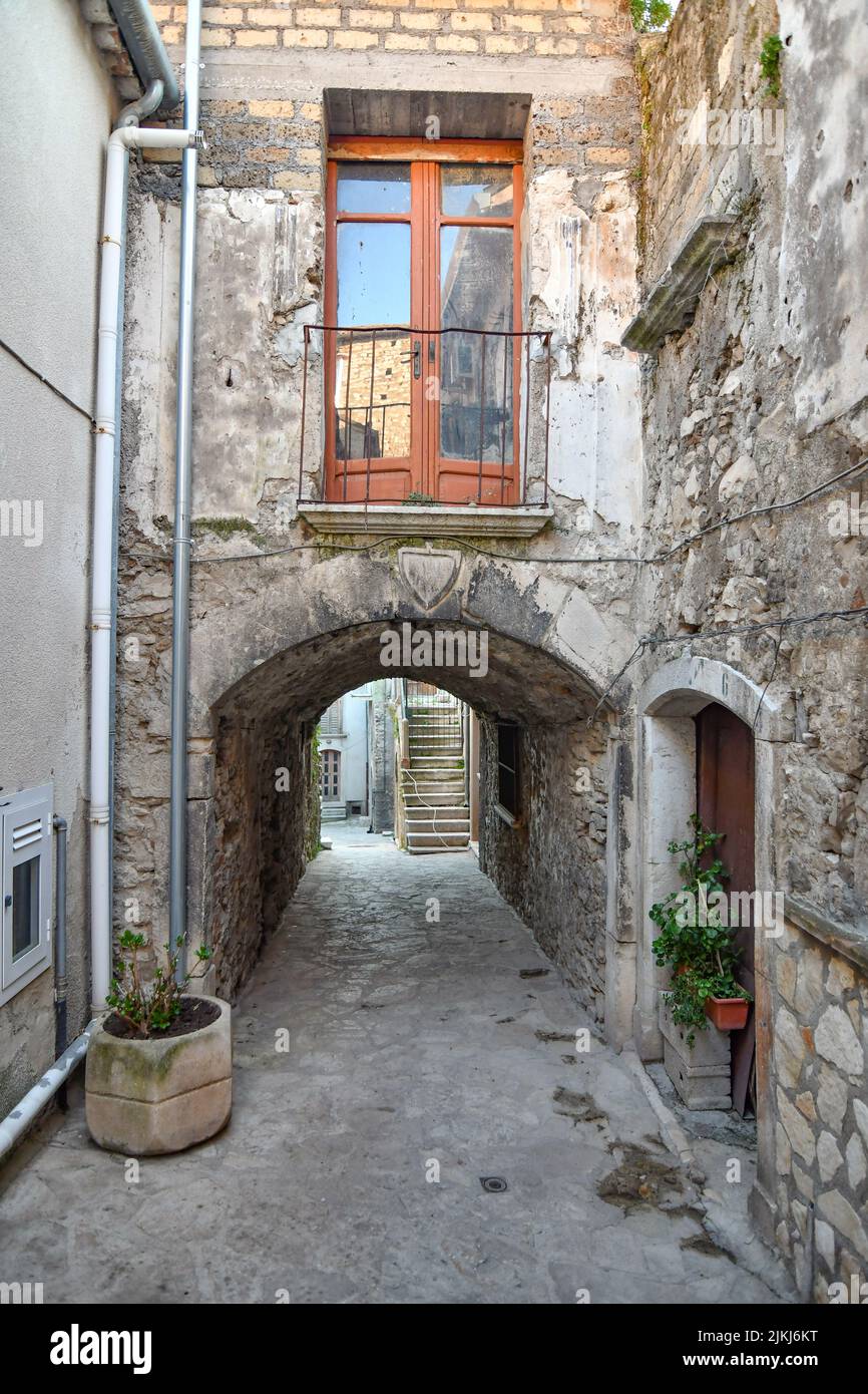 A narrow street between the old stone houses of Taurasi, a medieval town in Avellino province, Italy Stock Photo