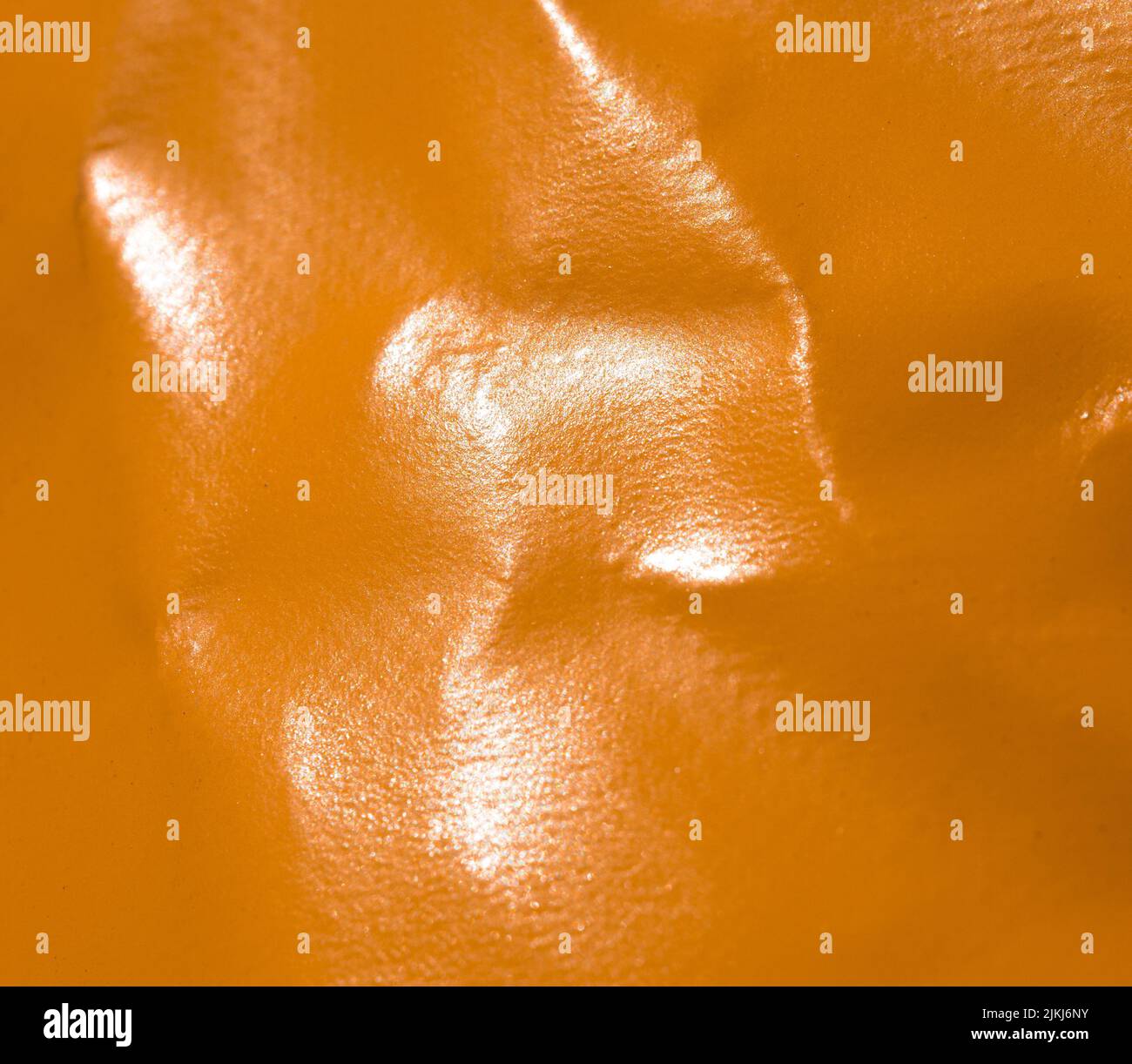 A closeup shot of an orange leather surface as a background Stock Photo