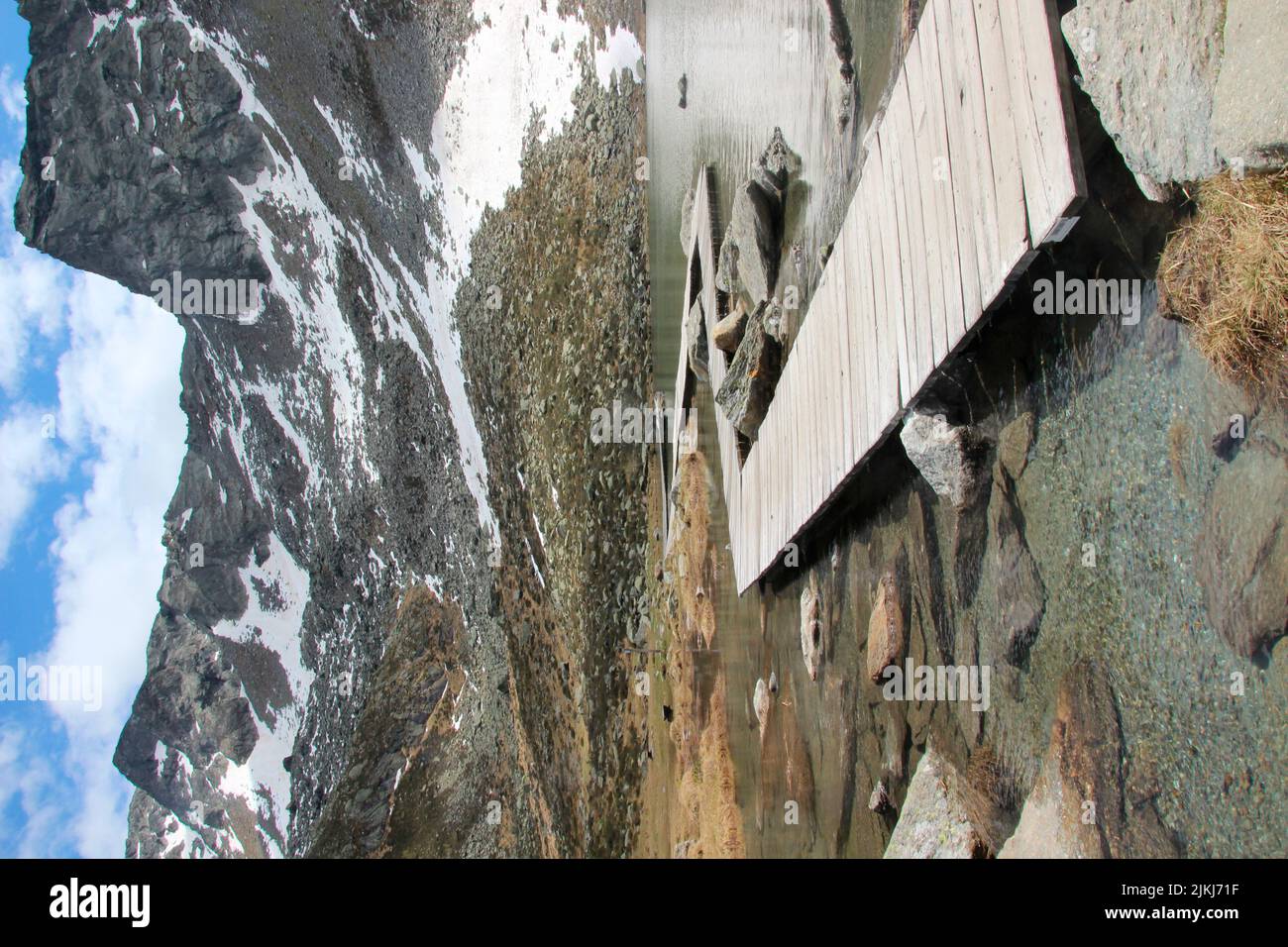 Hike to the Klaussee, footbridge at the lake, Klausberg near Steinhaus in Ahrntal, Pustertal, South Tyrol Italy Stock Photo