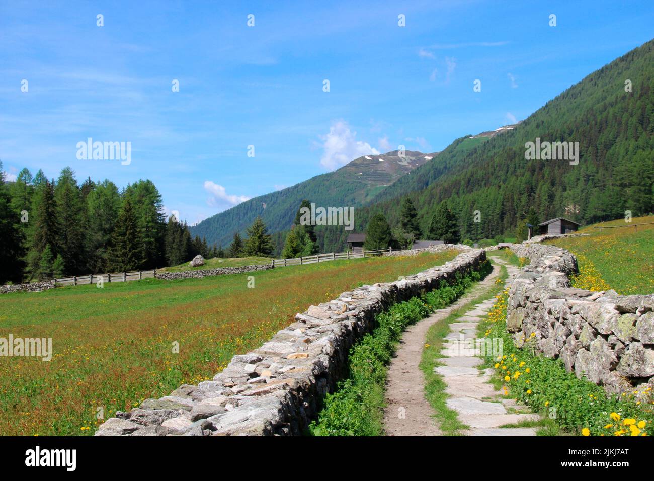 Path with stone walls between Prettau and Kasern, Ahrntal, Province of Bolzano, South Tyrol, Italy. near the Holy Spirit Chapel near Kasern. Stock Photo