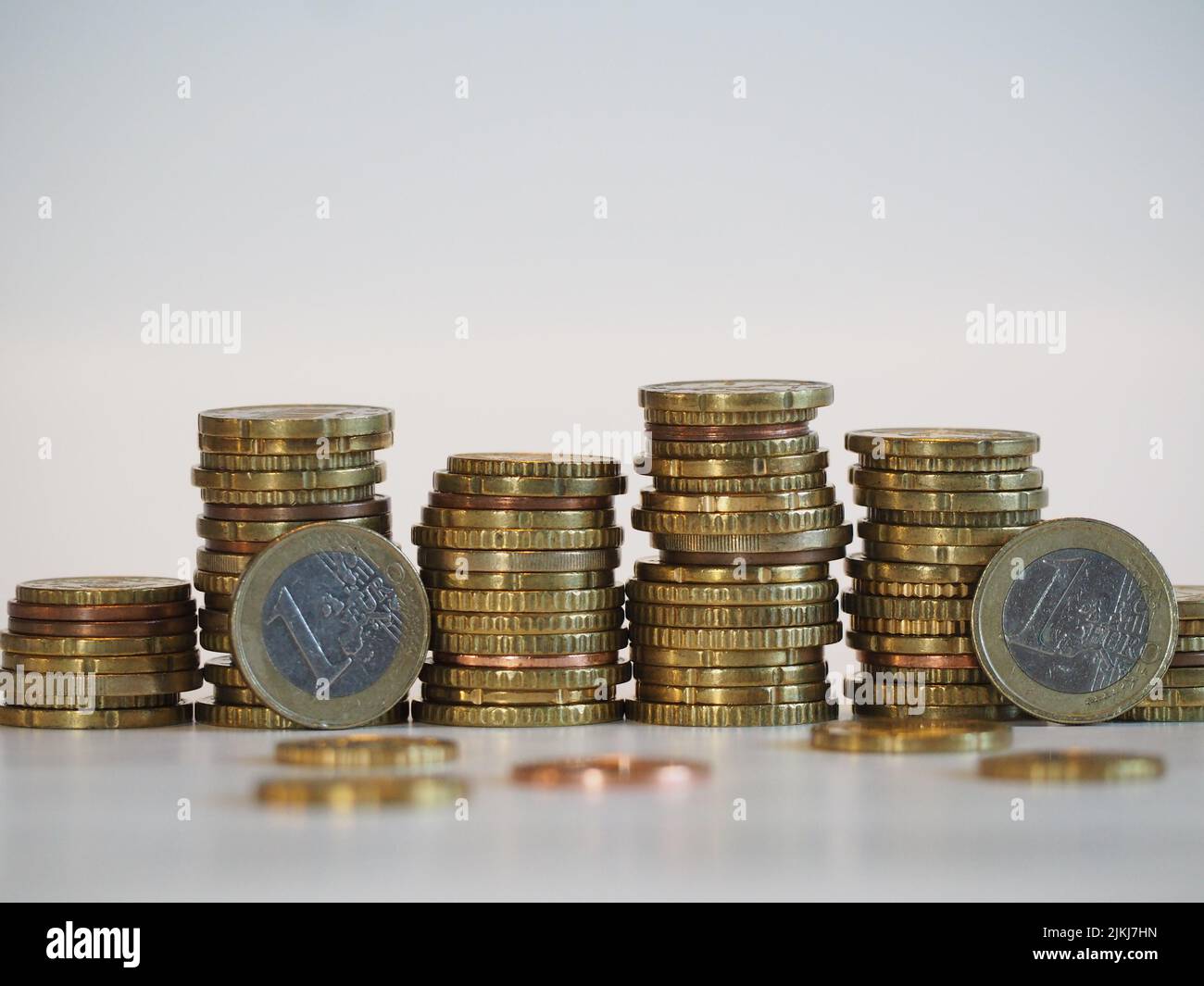 Isolated stacks of coins with one Euros on a white background Stock Photo