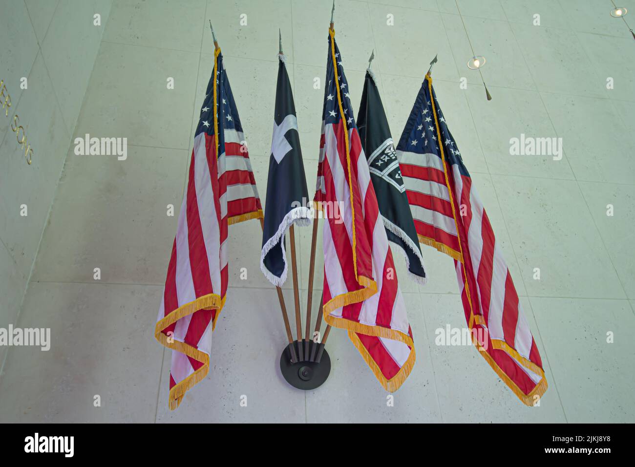 The American flags on the flagpole hanging on the wall Stock Photo